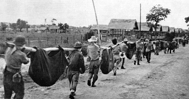 Carrying dead Americans and Filipinos who died on the "Death March" to Camp ODonnel for burial - April 1942